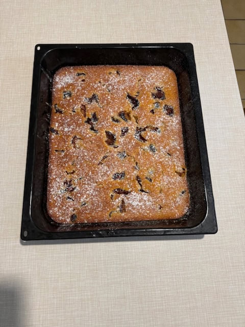 Homemade plum fruit cake baked in a large tray